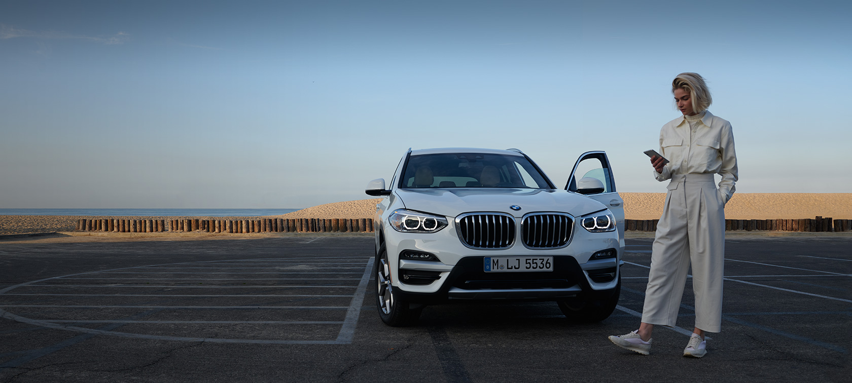My BMW App woman with smartphone My BMW App woman with smartphone
