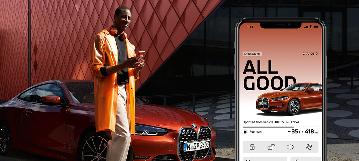 My BMW App manage my vehicle status woman leaning against the wall next to BMW My BMW App manage my vehicle status woman leaning against the wall next to BMW