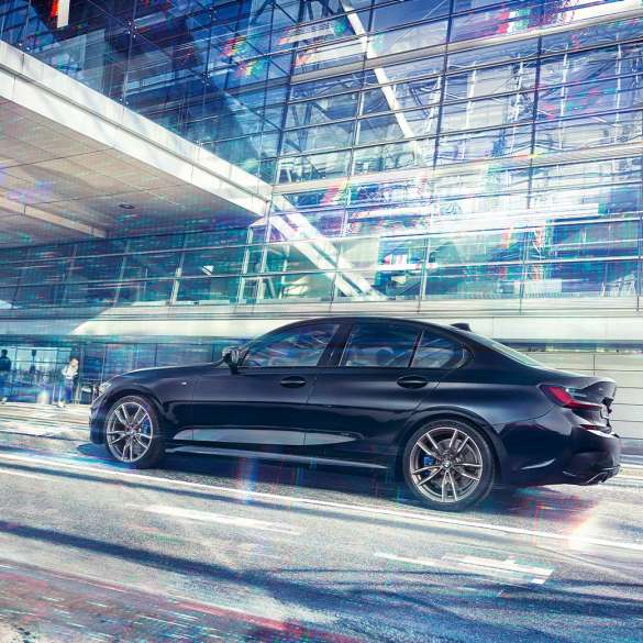 Side view BMW M340i xDrive Sedan BMW M340i xDrive Sedan G20 Sapphire Black metallic side view while driving