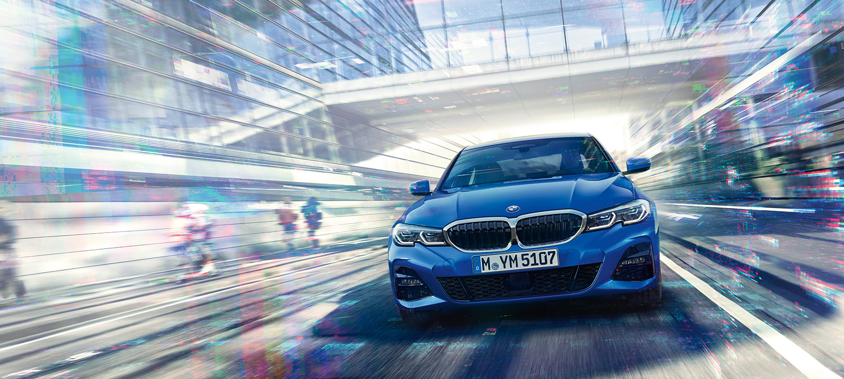 BMW 3 Series Sedan, front view. Front view of driving BMW 3 Series Sedan by day under glass building.