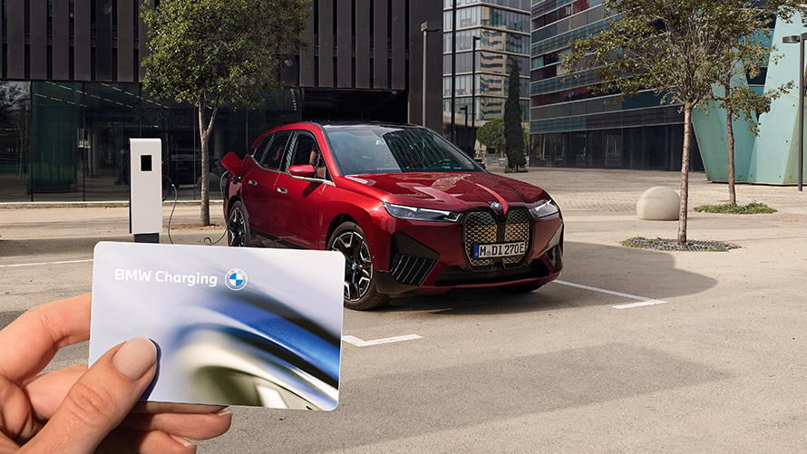 BMW iX i20 electric SUV BMW iX xDrive50 charging BMW iX i20 2021 electric SUV BMW iX xDrive50 Aventurin Red charging at a public high power charging station