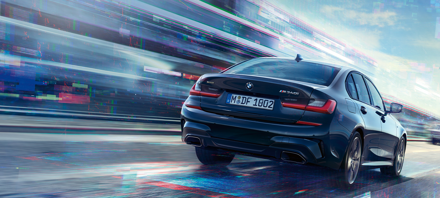 Rear view BMW M340i xDrive Sedan BMW M340i xDrive Sedan G20 Sapphire Black metallic rear view while driving