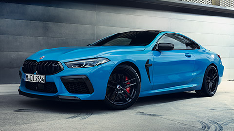 BMW M8 F92 three-quarter rear view standing with model BMW M Series BMW M8 F92 three-quarter rear view standing with model