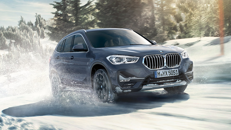 BMW X1 xDrive20i F48 LCI in BMW Individual Storm Baymetallic, driving in winter landscape BMW X1 xDrive20i F48 LCI in BMW Individual Storm Baymetallic, driving in winter landscape