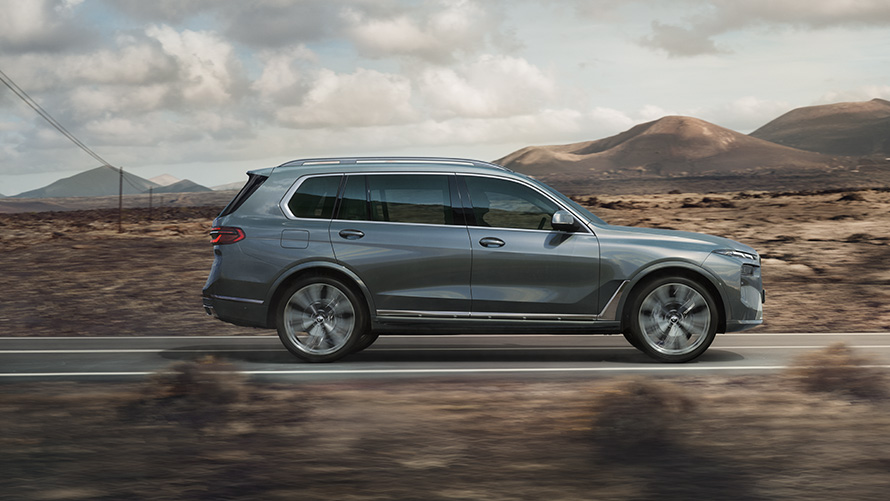 BMW X7 G07 LCI Side View Sparkling Copper Grey metallic BMW X7 G07 LCI Side View driving Sparkling Copper Grey metallic