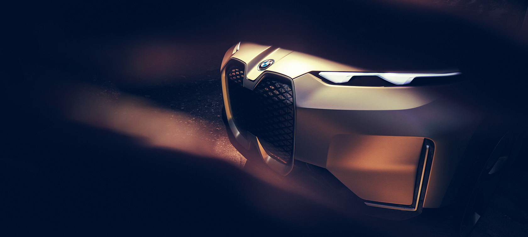 Three quarter front shot of the BMW Vision iNEXT in front of stone wall