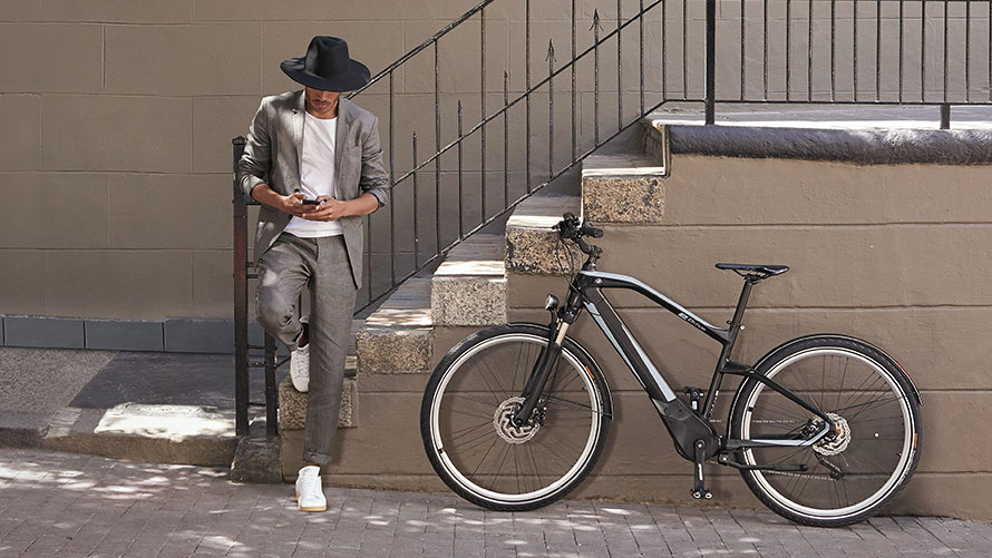 Man beside a BMW E-bike. Man beside a BMW E-bike.