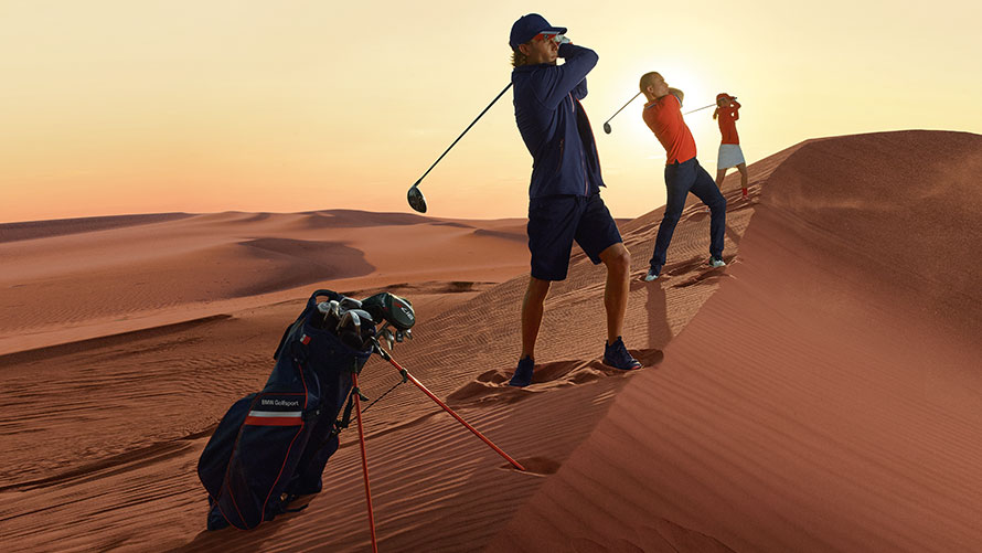 Man and woman in clothing and accessories from the BMW Golfsport Collection. Man and woman in clothing and accessories from the BMW Golfsport Collection.