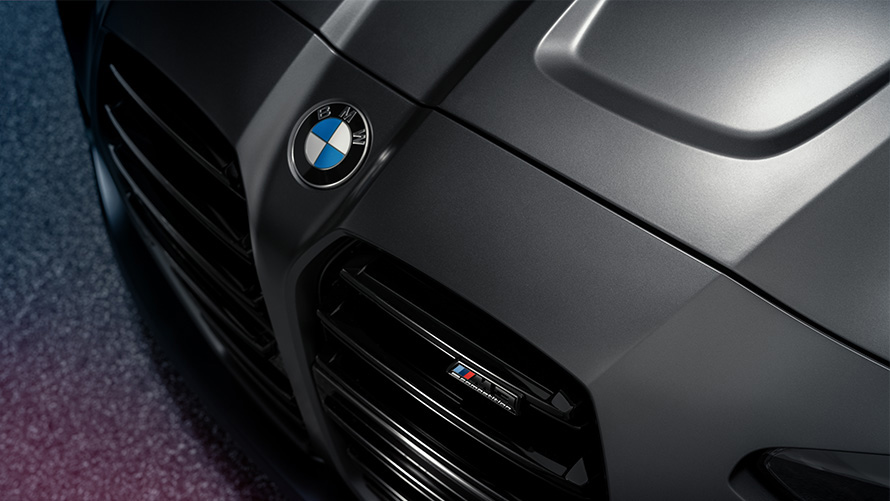 BMW M4 Competition Coupé G82 2021 Frozen Dark Grey metallic standing front view in section from above close-up BMW M4 Competition Coupé G82 2021 Frozen Dark Grey metallic standing front view in section from above close-up
