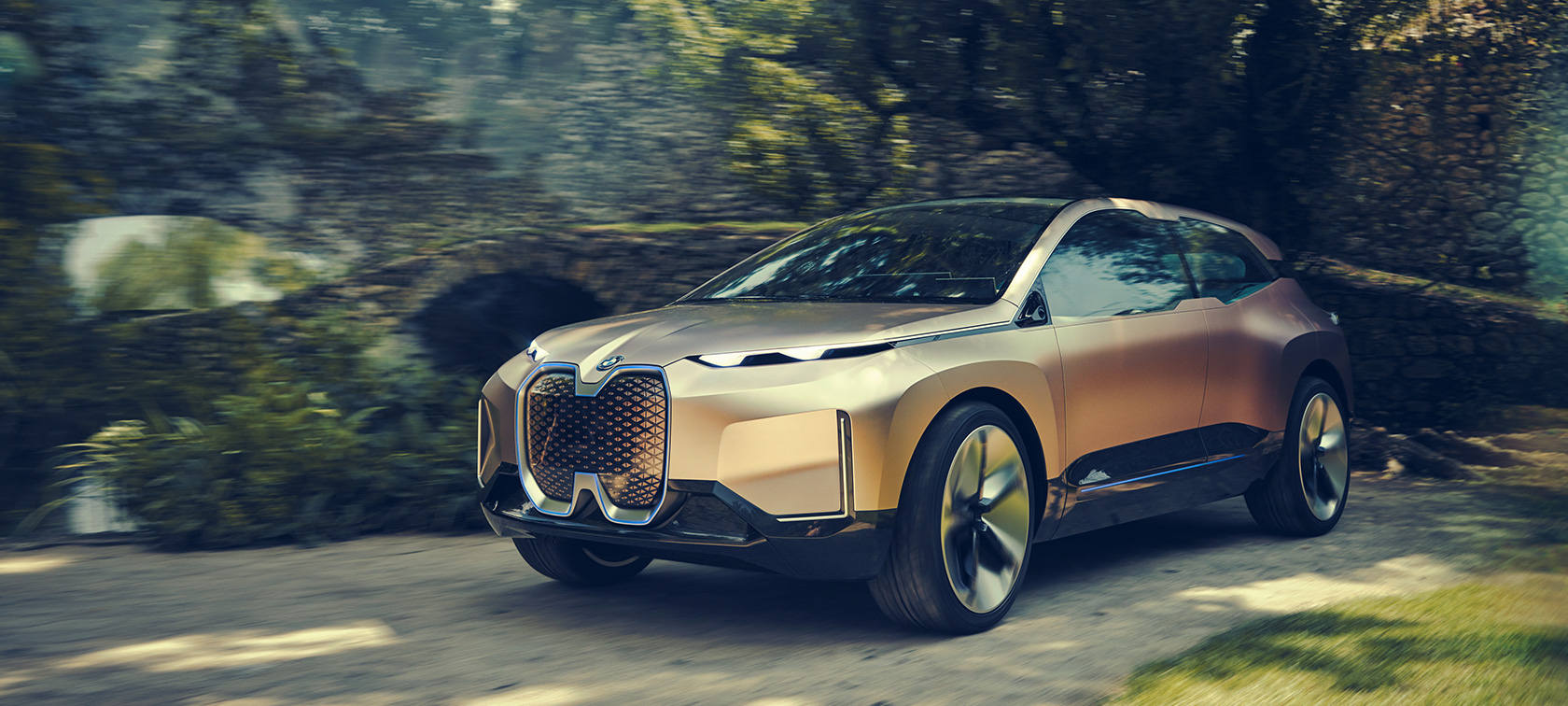 Three quarter front shot of the BMW Vision iNEXT in front of stone wall