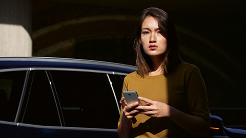 BMW ConnectedDrive overview BMW ConnectedDrive overview woman with smartphone in front of BMW