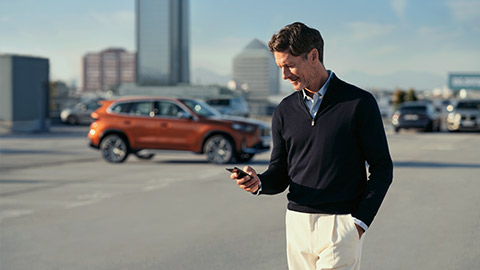 BMW ConnectedDrive My BMW App man with smartphone in his hands
