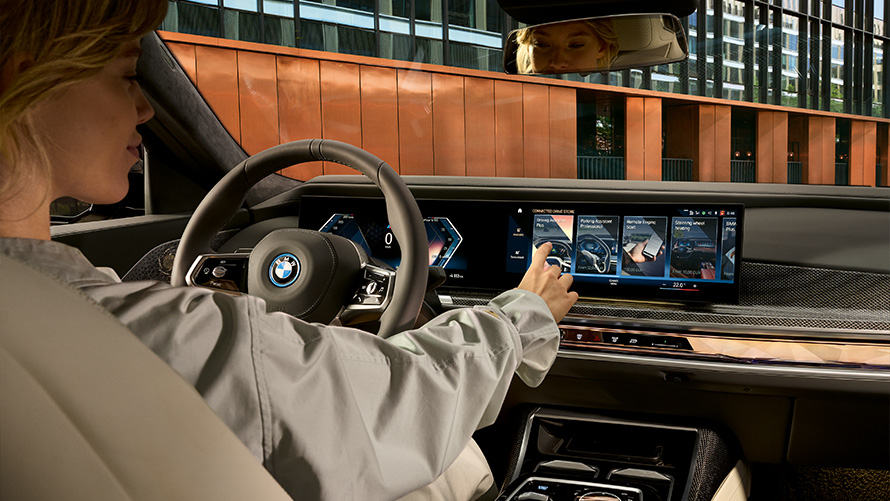 Bookable Functions BMW ConnectedDrive bookable functions Woman interacting with Touchscreen in the vehicle