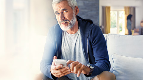 BMW ConnectedDrive BMW Store man sitting with smartphone in his hands