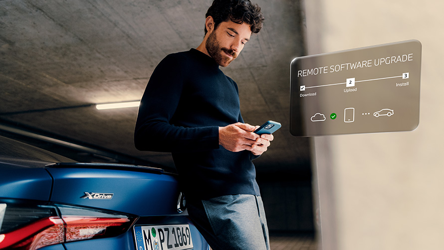 Remote Software Upgrade BMW ConnectedDrive Upgrades BMW ConnectedDrive Upgrades Remote Software Upgrade man with smartphone