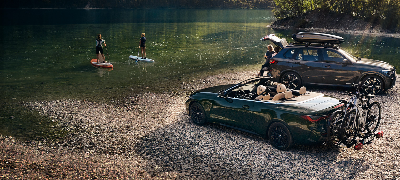 BMW vehicles in front of lake and green landscape BMW Spring Summer Accessories BMW vehicles in front of lake and green landscape