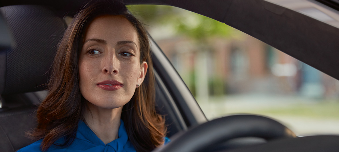 A woman sitting in her BMW smiling. A woman sitting in her BMW smiling.